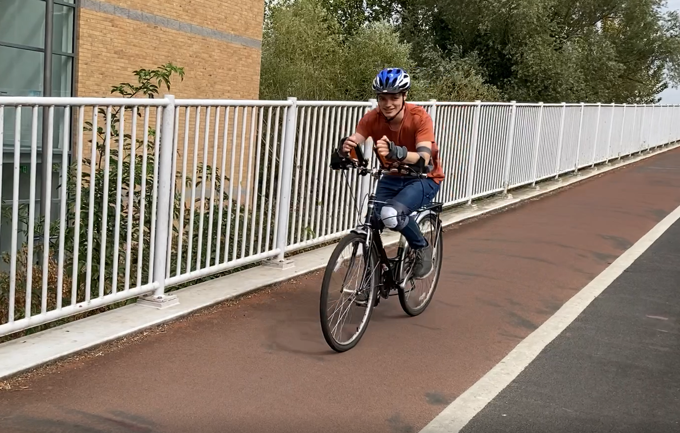 How can a wooden plank help amputees ride a bike?
